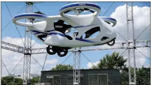  ?? AP/KOJI SASAHARA ?? A “flying car” hovers for about a minute at NEC Corp.’s facility in Abiko, about 40 miles northeast of Tokyo. Officials with the company said their drone-like vehicle is designed for unmanned flights.