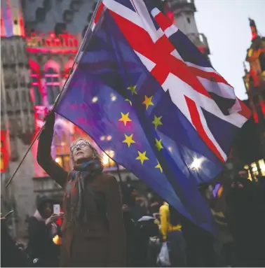  ?? FRANCISCO SECO/THE ASSOCIATED PRESS ?? A woman holds up the Union Jack and European Union flags during a “Brussels calling” event to celebrate the friendship between Belgium and Britain in Brussels on Thursday, after a vote that will allow the U.K. to exit from the EU.