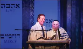  ?? ?? Holocaust survivor David Weiner, 96, right, speaks alongside Rabbi David Baron during services at Beverly Hills Temple of the Arts at the Saban Theatre on Wednesday.