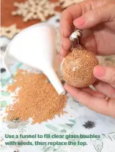  ??  ?? Use a funnel to fill clear glass baubles with seeds, then replace the top.