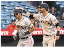  ??  ?? Mike Tauchman gets a pat on the head from Steven Duggar after Tauchman’s threerun home run in the 13th.