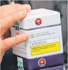  ??  ?? Becky Prete, 37, holds boxes of marijuana purchased at a cannabis store in Kamloops, British Columbia. Legal sales in Canada began Wednesday.