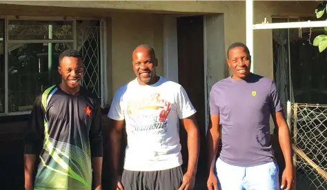  ?? -( Picture by Tristan ?? BROTHERS-IN-SPORT . . . The Masakadza brothers (from left) Wellington, Hamilton and Shingi relax at their family home in Harare. Holme)