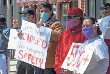  ?? ELI LUCERO/USA TODAY NETWORK VIA AP ?? Workers at JBS protest in Logan, Utah, the company’s handling of an outbreak .