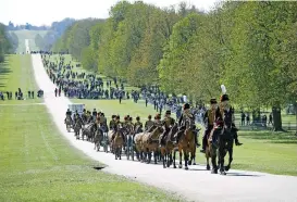  ?? (AFP) ?? Members of the King’s Troop Royal Horse Artillery ride up the Long Walk to Windsor Castle in Windsor, west of London, for the funeral of Britain’s Prince Philip, Duke of Edinburgh, on Saturday