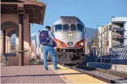  ?? EDDIE MOORE/JOURNAL ?? Just two people wait to board the northbound Rail Runner train at the South Capitol Station in Santa Fe on Wednesday.