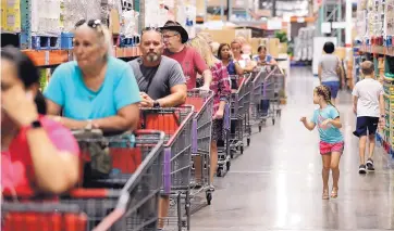  ?? JOE BURBANK/ORLANDO SENTINEL ?? Shoppers wait in line at a Costco store in Altamonte Springs, Florida. On Friday, the Commerce Department released U.S. retail sales data for August.