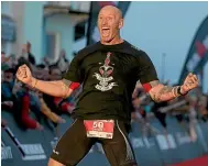  ?? GETTY IMAGES ?? Former Welsh rugby internatio­nal captain Gareth Thomas reacts after finishing Ironman Wales in Tenby.