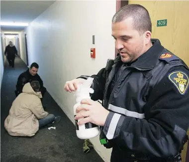  ?? GREG PENDER/The StarPhoeni­x ?? Acting Sgt. Preston Parranto of the Saskatoon Police Service takes a call about an intoxicate­d man on the west side on
Wednesday night. Parranto seized a container of hand sanitizer that the man possessed.