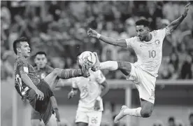  ?? Julio Cortez/associated Press ?? Mexico's Hirving Lozano and Saudi Arabia's Salem Al-dawsari battle for the ball during Wednesday's World Cup Group C match in Lusail, Qatar.