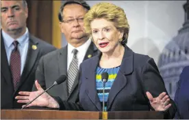  ?? AL DRAGO / THE NEW YORK TIMES ?? Sen. Debbie Stabenow, D-Mich., speaks at a news conference calling for assistance for the drinking water crisis in Flint, Mich., to be included in a government funding bill, on Capitol Hill on Wednesday. From left are Rep. Dan Kildee, Sen. Gary Peters...