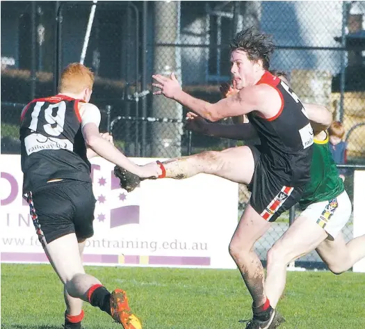  ??  ?? Warragul’s Sam Russell just avoids team mate Nick Stevenson to get a clearing kick away as Leongatha applied the pressure in Saturday’s Gippsland League clash at Western Park. Russell helped the Gulls get away to a flying sstart kicking his side’s...