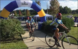  ?? Jonathan Bissonnett­e/The Call ?? Brett Lukaszek of Chelsea, Mass. (foreground) and Ryan Johnstone of Newton, Mass. (background) ride their bicycles through Woonsocket en route to Newport for the annual Bike to the Beach.