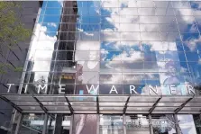  ??  ?? Clouds are reflected in the glass facade of the Time Warner building in New York. A judge has ruled that the merger of Time Warner and AT&T can go ahead, although the Justice Department may still appeal the ruling.