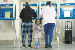  ?? MORRY GASH/AP ?? K-Lee, 3, waits as her mother, Heather Ramsey, votes April 2 during the primary election in Milwaukee, Wisconsin. President Biden’s support in polls has inched up lately.