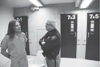  ?? Photos by Andy Cross, The Denver Post ?? Jefferson County inmate and Army National Guard veteran Dale Murphy, left, talks with Jeffco Sheriff ’s Division Chief Dan Gard in the new Veterans jail unit.