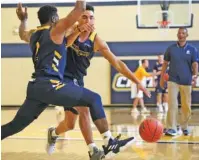  ?? STAFF PHOTO BY ERIN O. SMITH ?? UTC’s Jerry Johnson (2) guards Jonathan Scott while working on drills in the Chattem Practice Facility. The Mocs will face a different team when Lee’s Flames visit for an exhibition tonight in McKenzie Arena.