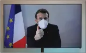  ?? CHARLES PLATIAU — POOL ?? French President Emmanuel Macron is seen on a screen as he attends by video conference a round table for the National Humanitari­an Conference taken at the Foreign Ministry in Paris on Thursday.