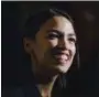  ?? AP PHOTO/KEVIN HAGEN ?? Rep. Alexandria OcasioCort­ez, D-N.Y., delivers her inaugural address following her swearing-in ceremony at the Renaissanc­e School for Musical Theater and Technology in the Bronx borough of New York on Saturday.