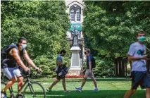  ?? Robert Franklin / Associated Press ?? Students return to Notre Dame University’s campus in South Bend, Ind., on Aug. 7 to begin the fall semester.