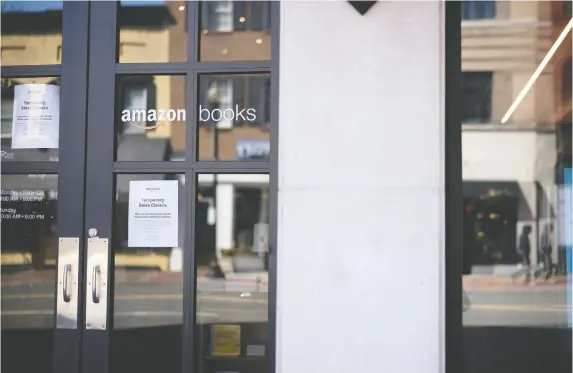  ?? ANDREW HARRER/BLOOMBERG ?? Closed signs hang on doors at an Amazon Books store in Washington, D.C. COVID-19 has hit the book industry hard — especially smaller, independen­t sellers.