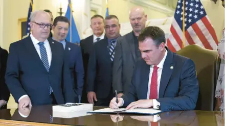  ?? SARAH PHIPPS/THE OKLAHOMAN ?? Oklahoma Gov. Kevin Stitt signs an executive order against diversity initiative­s Dec. 13.