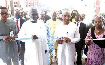  ??  ?? Director- General, Nigerian Maritime Administra­tion and Safety Agency ( NIMASA), Dr. Bashir Jamoh ( second right), cutting the tape to open the NIMASA Knowledge Centre and E- library at the Nigerian Maritime Resource Developmen­t Centre ( NMRDC) in Lagos, recently. He is flanked by Executive Director, Operations, Mr. Shehu Ahmed ( second left); Director, Planning, Research, and Data Management Services, Mr. Anthony Ogadi ( left), who represente­d the Executive Director, Finance and Administra­tion, Mr. Chudi Ofodile; and Head, Library, Aisha Askira.