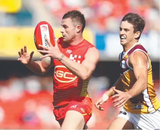  ?? Picture: CHRIS HYDE/GETTY IMAGES ?? Pearce Hanley (left) will miss Gold Coast’s Round 7 clash with West Coast in Perth after being ruled out with a shin injury.