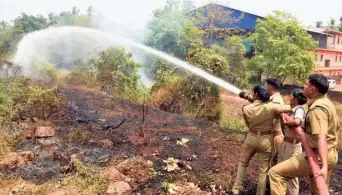  ?? K. RAGESH ?? Timely act: Firefighte­rs trying to douse a fire near the railway track at Cheruvannu­r in Kozhikode on Wednesday. Incidents of small and sudden fires have become commonplac­e as the mercury has risen beyond 36 degrees Celsius.