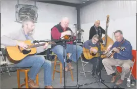  ?? STAFF PHOTOS BY TIFFANY WATSON ?? The band CrossRoads performed bluegrass music during the Kris Kringle Christmas Market at the Charles County Fairground­s on Dec. 10.