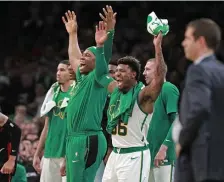  ?? MATT STONE / BOSTON HERALD ?? BACK TO WINNING WAYS: Marcus Smart (36) and Guerschon Yabusele celebrate during the Celtics’ 117-108 victory against the Toronto Raptors last night at the Garden.