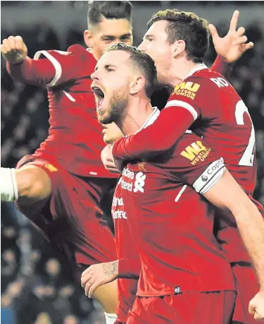 ??  ?? Screaming match: Jordan Henderson leads the celebratio­ns as Liverpool cruise to victory