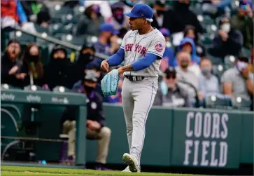  ?? AP PHOTO BY DAVID ZALUBOWSKI ?? New York Mets starting pitcher Marcus Stroman points to his glove after stopping a ground ball off the bat of Colorado Rockies’ Josh Fuentes in the eighth inning of a baseball game Sunday, April 18, in Denver.