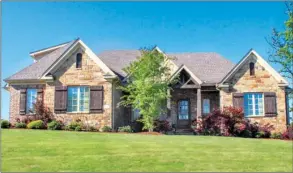  ?? PHOTOS BY LINDA GARNER-BUNCH/Arkansas Democrat-Gazette ?? Inside this stone and brick home are four bedrooms, three-and-a-half baths, an upstairs bonus room and more. A screened porch, a deck and a  agstone porch offer beautiful vista views.