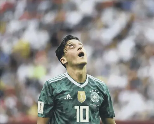  ??  ?? 0 Midfielder Mesut Ozil reacts during Germany’s stunning defeat by South Korea, which eliminated the holders from the World Cup.