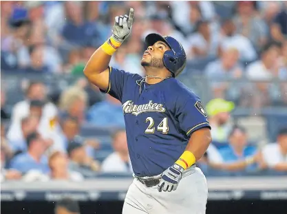  ??  ?? The Brewers’ Jesus Aguilar celebrates after hitting a second inning two-run home run against the Yankees.
