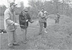  ?? PHOTOS BY PAUL A. SMITH ?? Volunteers from Trout Unlimited pair up with people who have Parkinson Disease at a fly fishing outing at Rushing Waters Trout Farm.