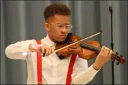  ?? LYRIC AQUINO — THE MORNING JOURNAL ?? Pablo J. Oquendo II, a Lorain High School student, performs “Lift Every Voice and Sing” March 7 at the Lorain Club of The National Associatio­n of Negro Business and Profession­al Women’s Clubs Inc. Women’s History Annual Tea.