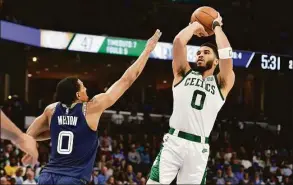  ?? Brandon Dill / Associated Press ?? Boston Celtics forward Jayson Tatum shoots against Memphis Grizzlies guard De’Anthony Melton in the first half on Sunday in Memphis, Tenn.