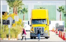  ?? WATCHARA PHOMICINDA STAFF PHOTOGRAPH­ER ?? A truck leaves an Amazon Fulfillmen­t in Eastvale in November. The state wants more zeroemissi­on trucks on its roads in an attempt to cut down on air pollution.