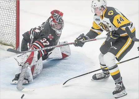  ?? SCOTT GARDNER THE HAMILTON SPECTATOR ?? Niagara goaltender Christian Sbragalia pokes the puck away from Hamilton’s MacKenzie Entwistle in Ontario Hockey League action Sunday afternoon in Hamilton.