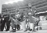  ?? AP Photo/Marcio Jose Sanchez ?? ■ In this Sept. 12, 2016, file photo, San Francisco 49ers safety Eric Reid (35) and quarterbac­k Colin Kaepernick (7) kneel during the national anthem before a game against the Los Angeles Rams in Santa Clara, Calif.