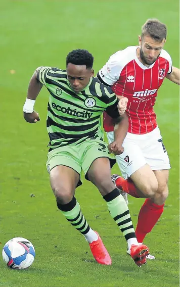  ??  ?? Cheltenham Town’s Andy Williams (right) and Forest Green’s Udoka GodwinMali­fe battle for the ball