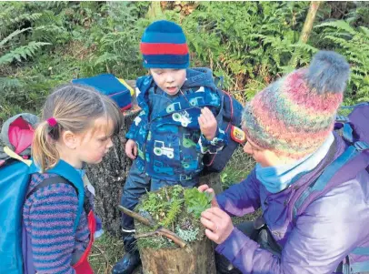  ??  ?? Youngsters play outside at Wee Wild Sparks outdoor nursery in Coupar Angus. As well as it being easier to observe social distancing in a big open space, the outdoor environmen­t can also be very therapeuti­c for children.