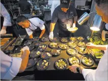  ?? Richard Brian ?? Las Vegas Review-journal @vegasphoto­graph Chefs from Aria Las Vegas prepare plates for UNLVINO guests.