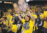  ?? Santiago Mejia / The Chronicle ?? Fan Dee Pangan holds cutouts of Stephen Curry and Klay Thompson during a playoff win at Oracle Arena.
