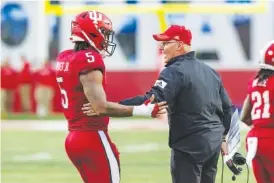  ?? AP PHOTO/DOUG MCSCHOOLER ?? In 2022, Indiana coach Tom Allen talks with quarterbac­k Dexter Williams II (5) during the team's NCAA college football game against Penn State in Bloomingto­n, Ind. Indiana opens their season at home against Ohio State on Sept. 2.