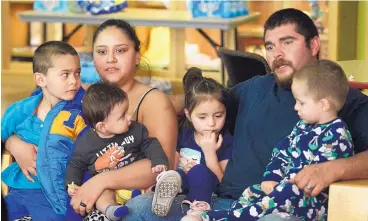  ?? GREG SORBER/JOURNAL ?? Jaqueline Arellano and her fiancé, Daniel Crespin, talk in the Manzano Mesa Multigener­ational Center on Monday about their escape from a fire at their apartment building on Sunday. With them are their children, from left, Francisco Arellano Crespin, 5;...