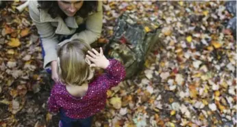  ?? CHERYL SENTER PHOTOS/THE NEW YORK TIMES ?? Jane Sweet, 2, readjusts her cochlear implant with the help of her mother, Laura, in Cumberland, Maine.