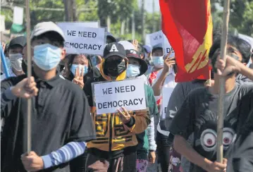  ?? AFP ?? Protesters holding signs as they march in a demonstrat­ion against the military coup in Dawei on Tuesday.